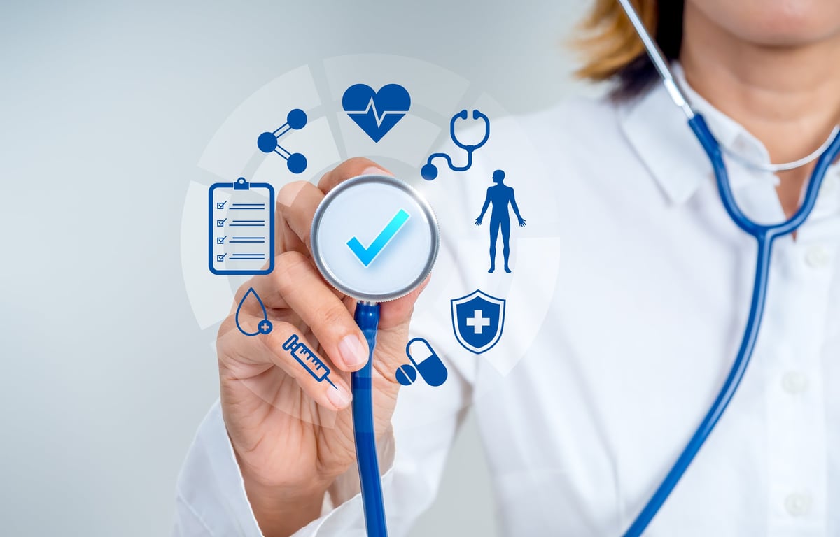 Doctor holding stethoscope with healthcare icons
