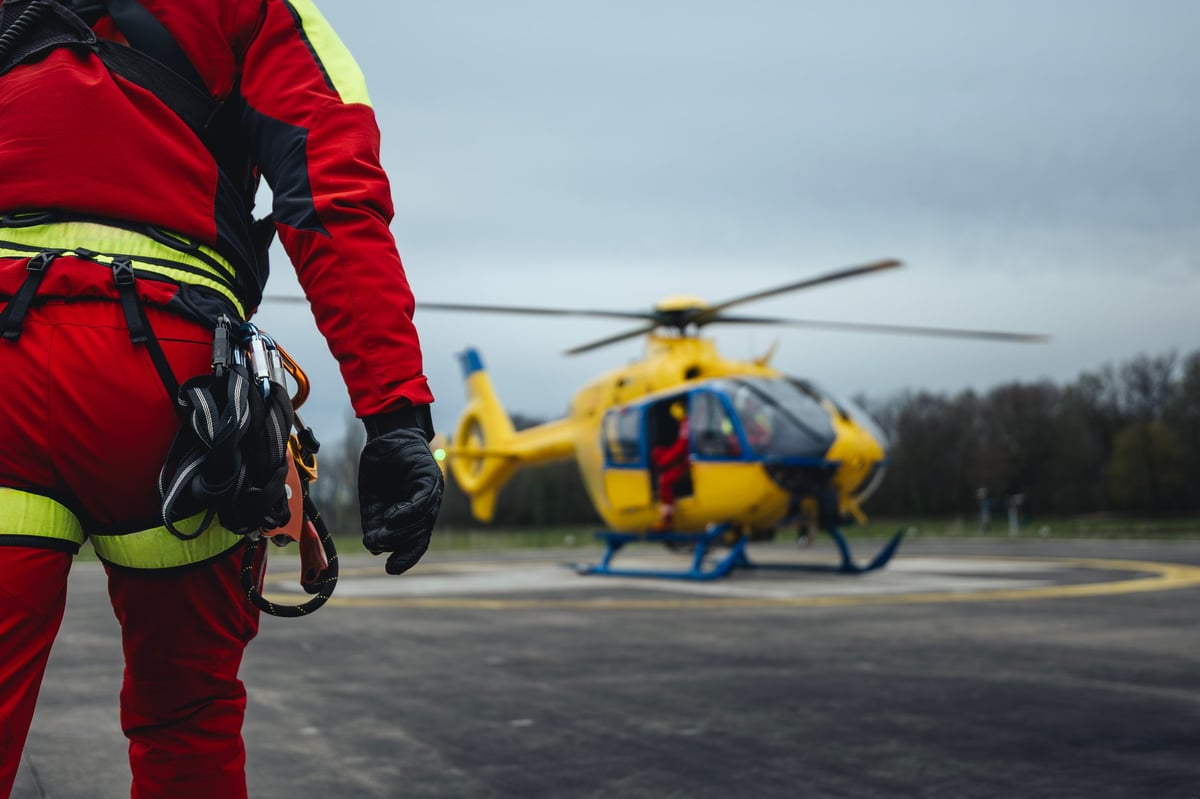Paramedic running to helicopter of emergency medical service